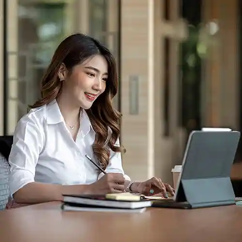 Woman reviewing payroll data on a tablet using UBS Payroll Software